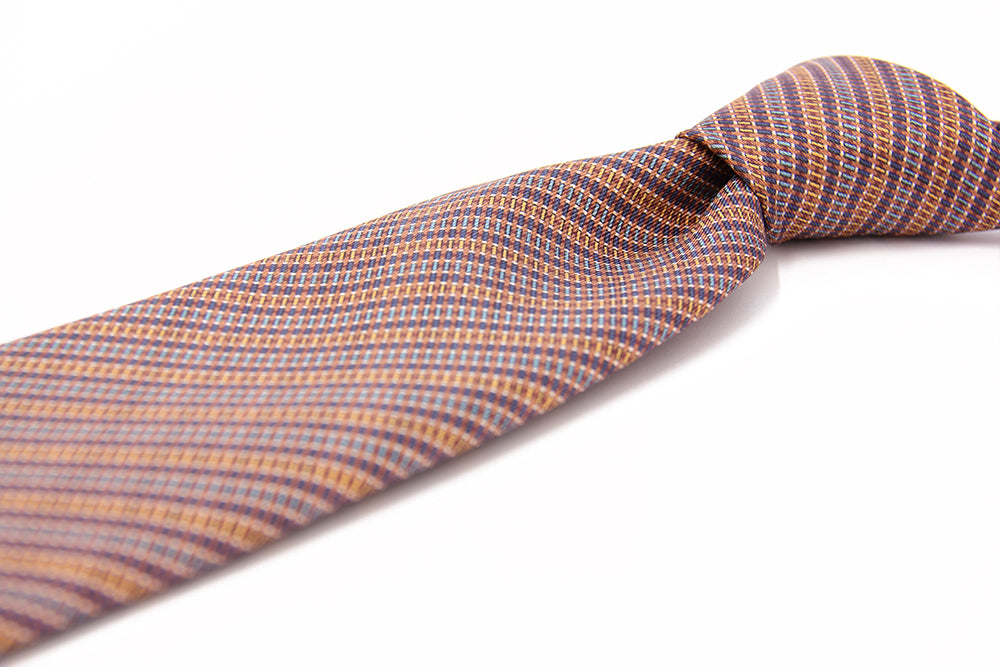 A silk tie with a geometric pattern in orange and white colors, displayed on a white background.