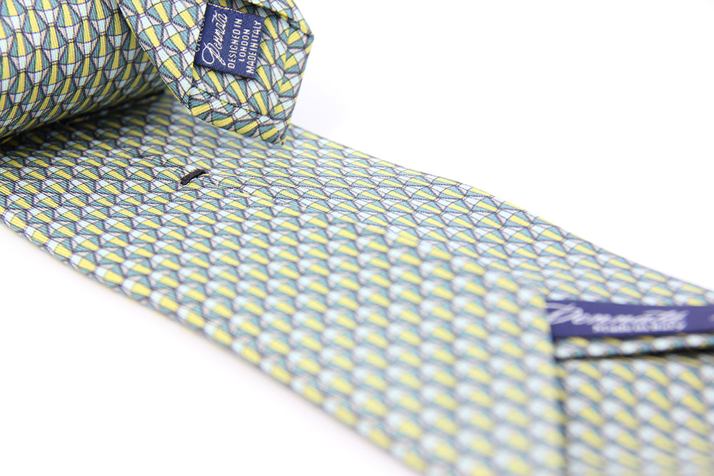 A silk tie with a geometric pattern in green and white colors, displayed on a white background.