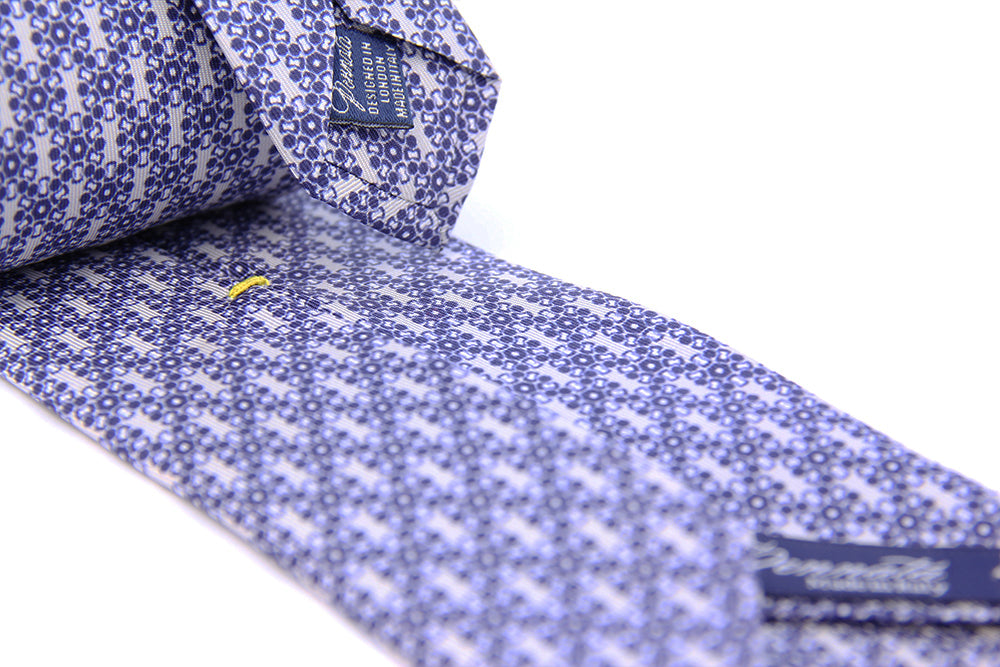 Detail of a blue silk tie geometric pattern