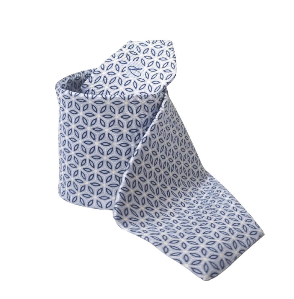 Blue patterned silk necktie, handmade in Italy on a white background