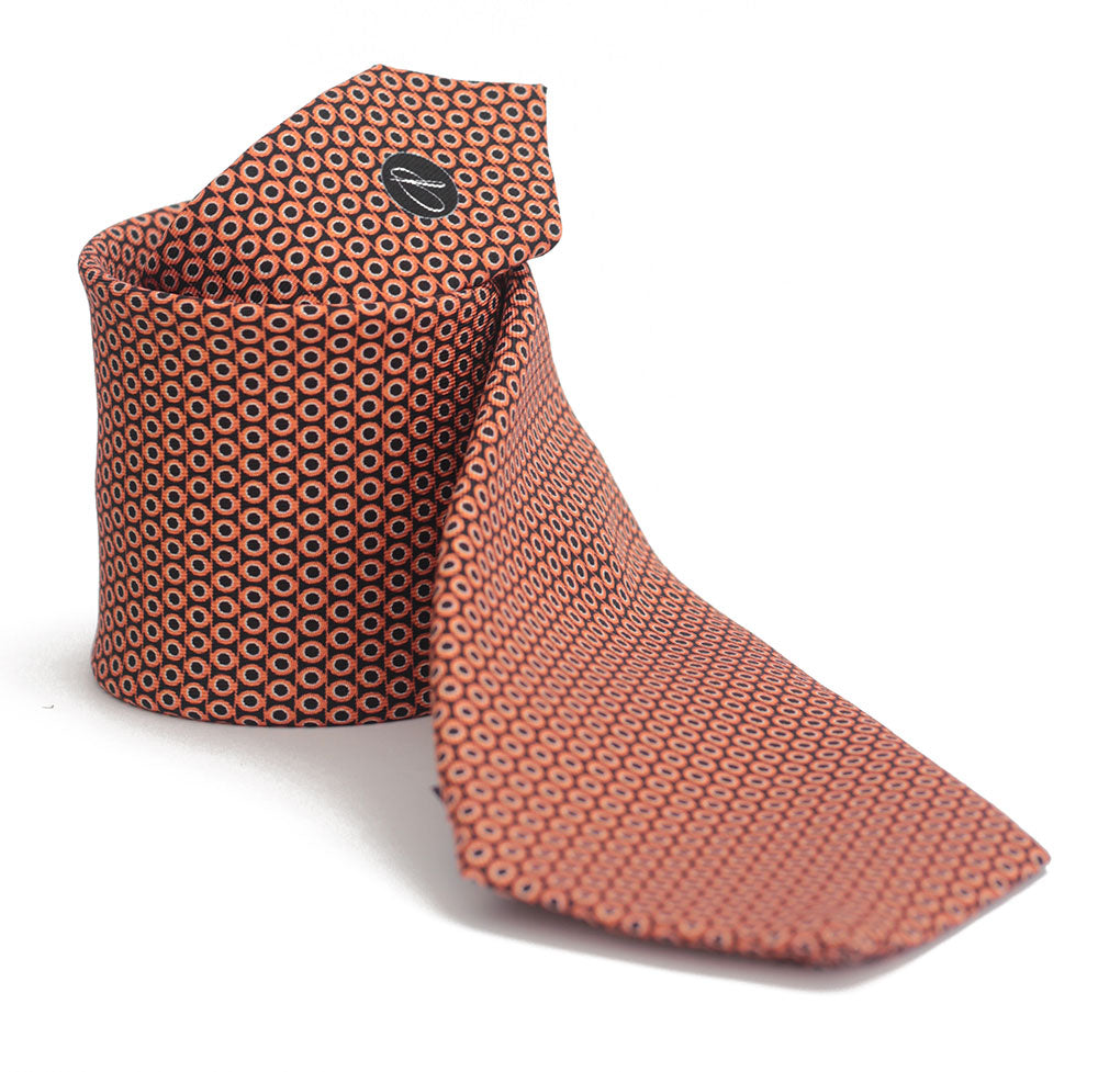 A orange tie with a geometric pattern of circles and dots on a white background, displayed in a folded and unfolded configuration.