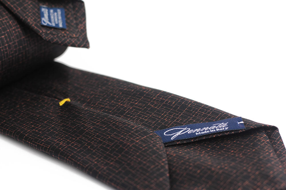 Close up of an elegant black gold silk tie