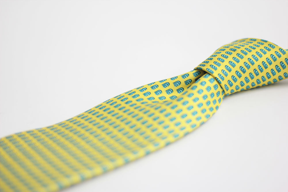 Detail of a geometric yello silk tie