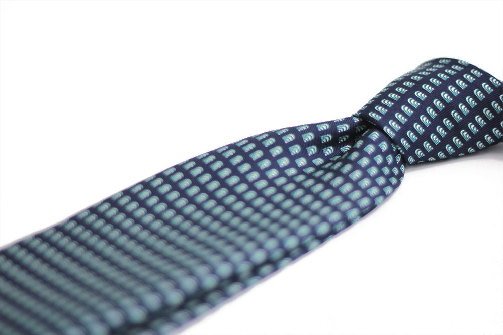 Detail of a geometric blue, dark blue silk tie