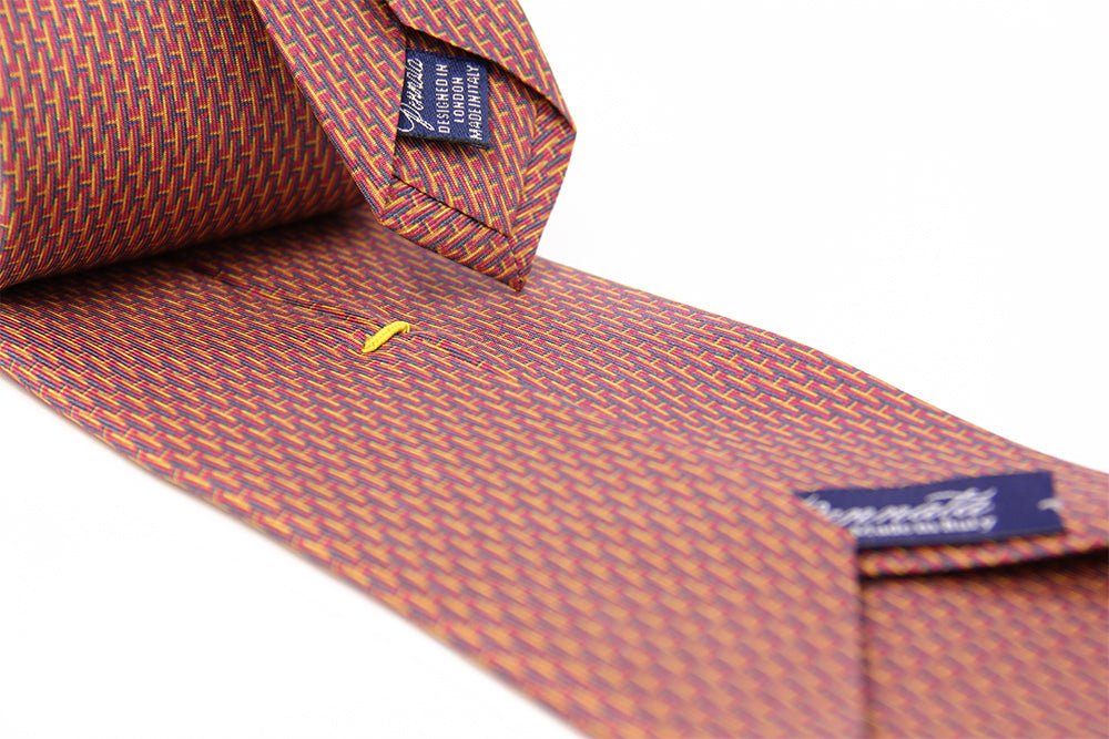 Closeup of a pattern of amaranth designers silk tie