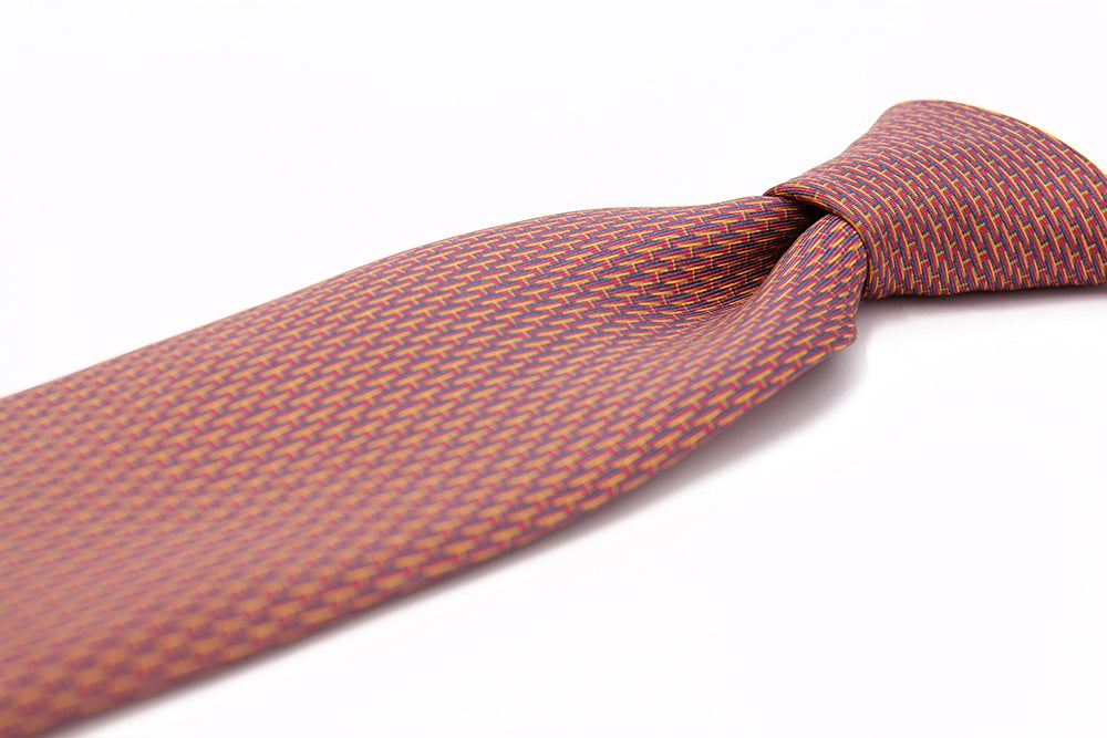 Closeup of a knot of amaranth designers silk tie