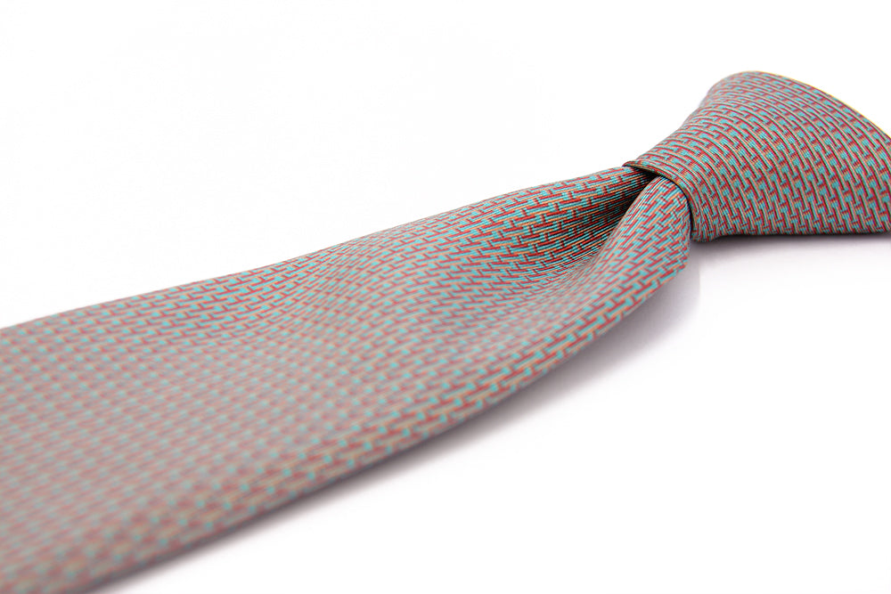 Close up of a patterned designers silk tie turquoise