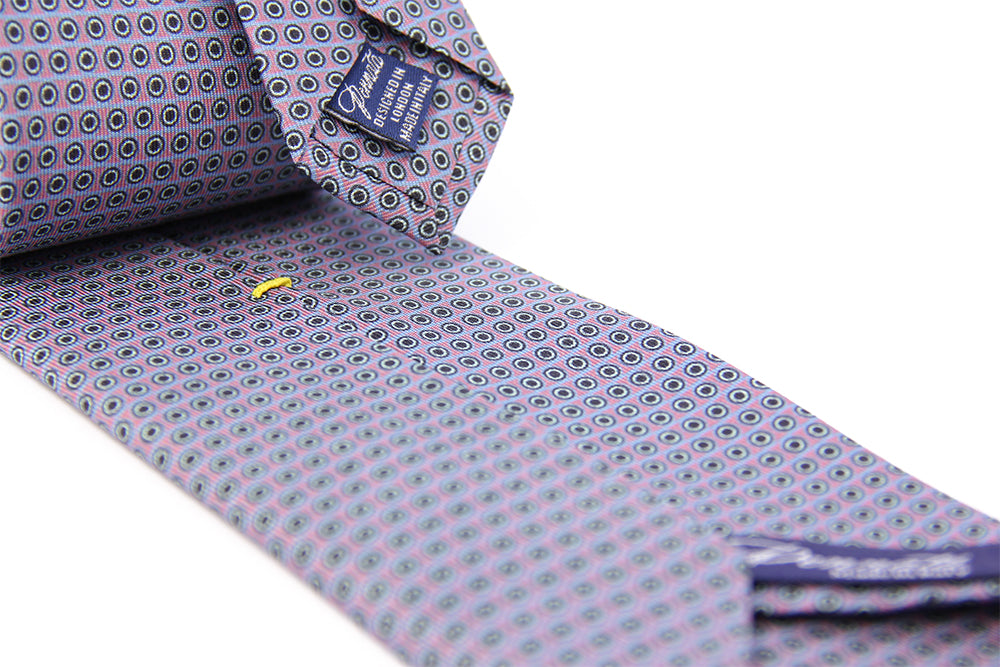 A patterned silk tie with a combination of violet and black colors, displayed in a folded and unfolded configuration.