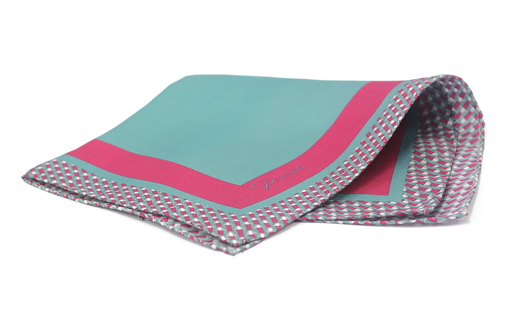 A folded pocket square with a geometric pattern, predominantly pink and blue in color.