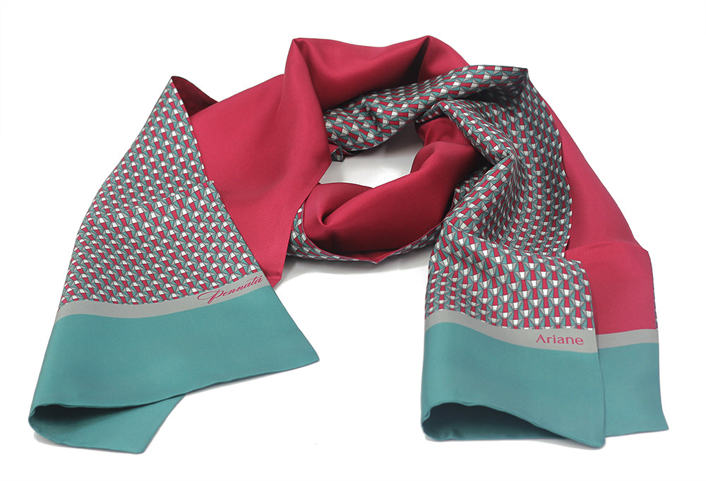 A scarf with geometric patterns, featuring colors red, blue, and gray, with the brand name 'MULBERRY' visible.