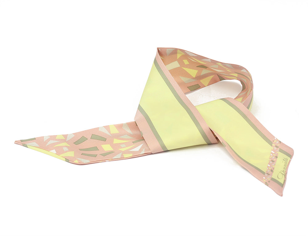 A silk scarf with a floral pattern in shades of pink, yellow, and green.