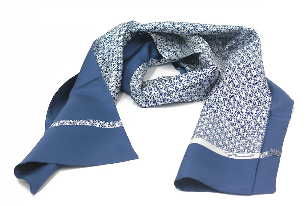 A silk pocket square with a blue and white geometric pattern.