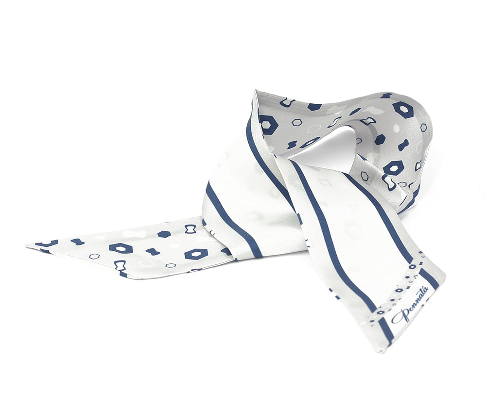 A folded silk twilly with a geometric pattern in silver and blue colors.