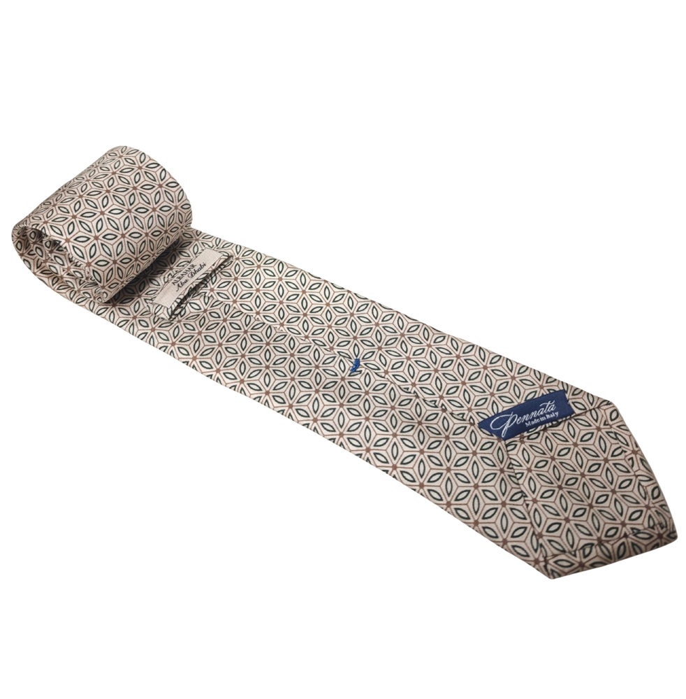 Patterned silk tie with a brand logo on a white background