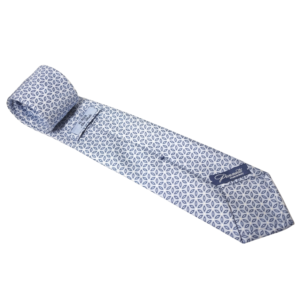 Blue patterned silk tie with a brand logo on a white background