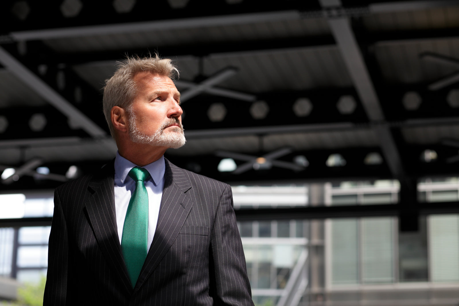 elegant man with silk green tie in an urban surrounding