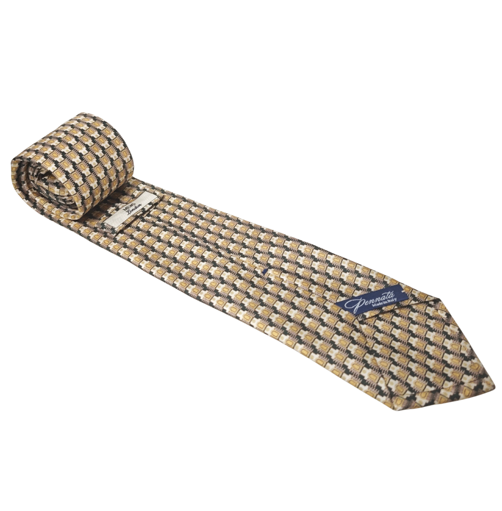 Patterned silk tie with a brand label on a white background