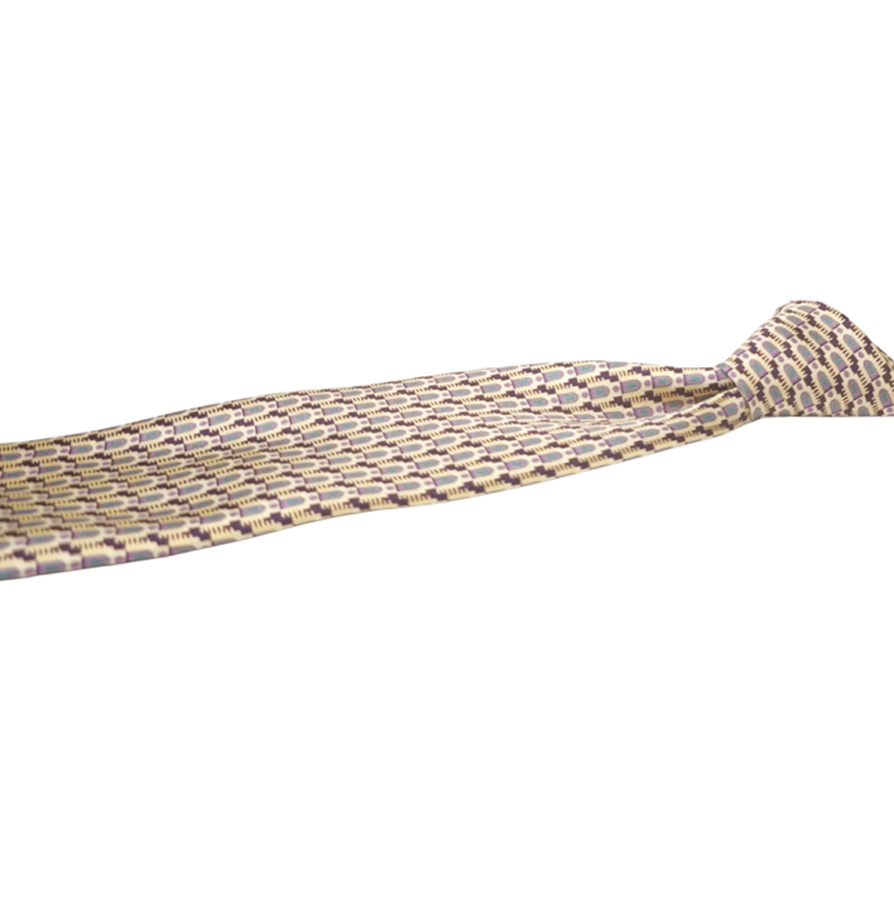 Patterned gold silk tie on a white background