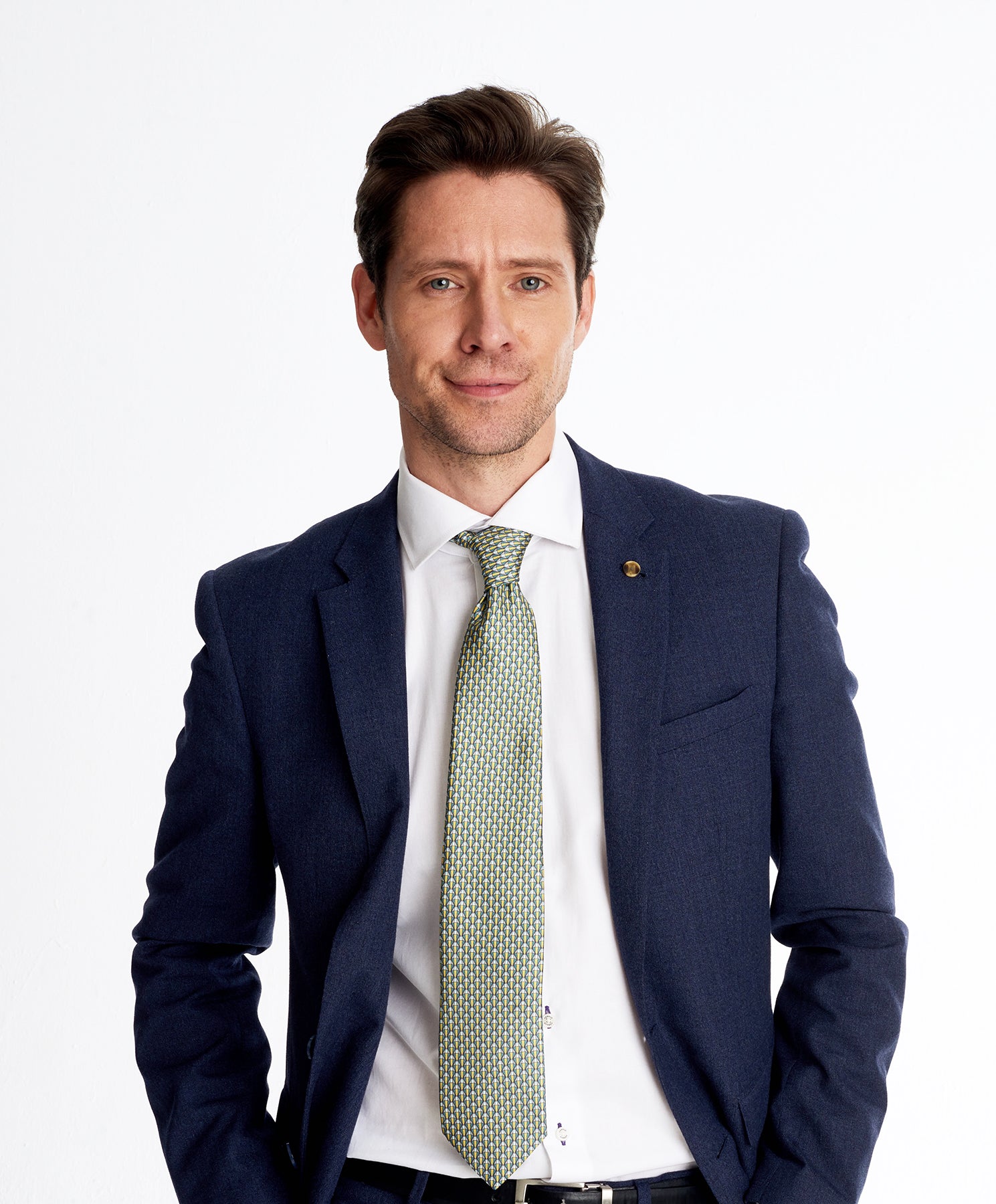 Elegant man wearing a designers green geometric silk tie
