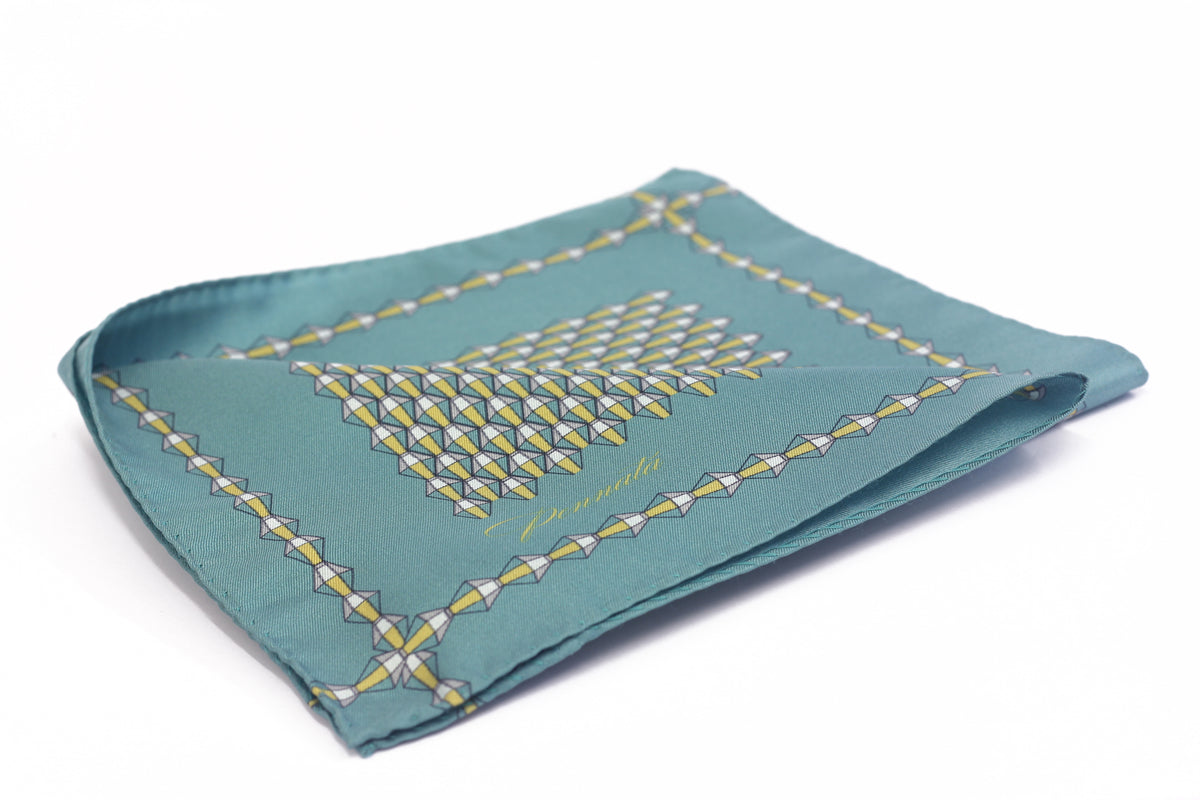 A folded Oxford green pocket square with geometric embroidery.