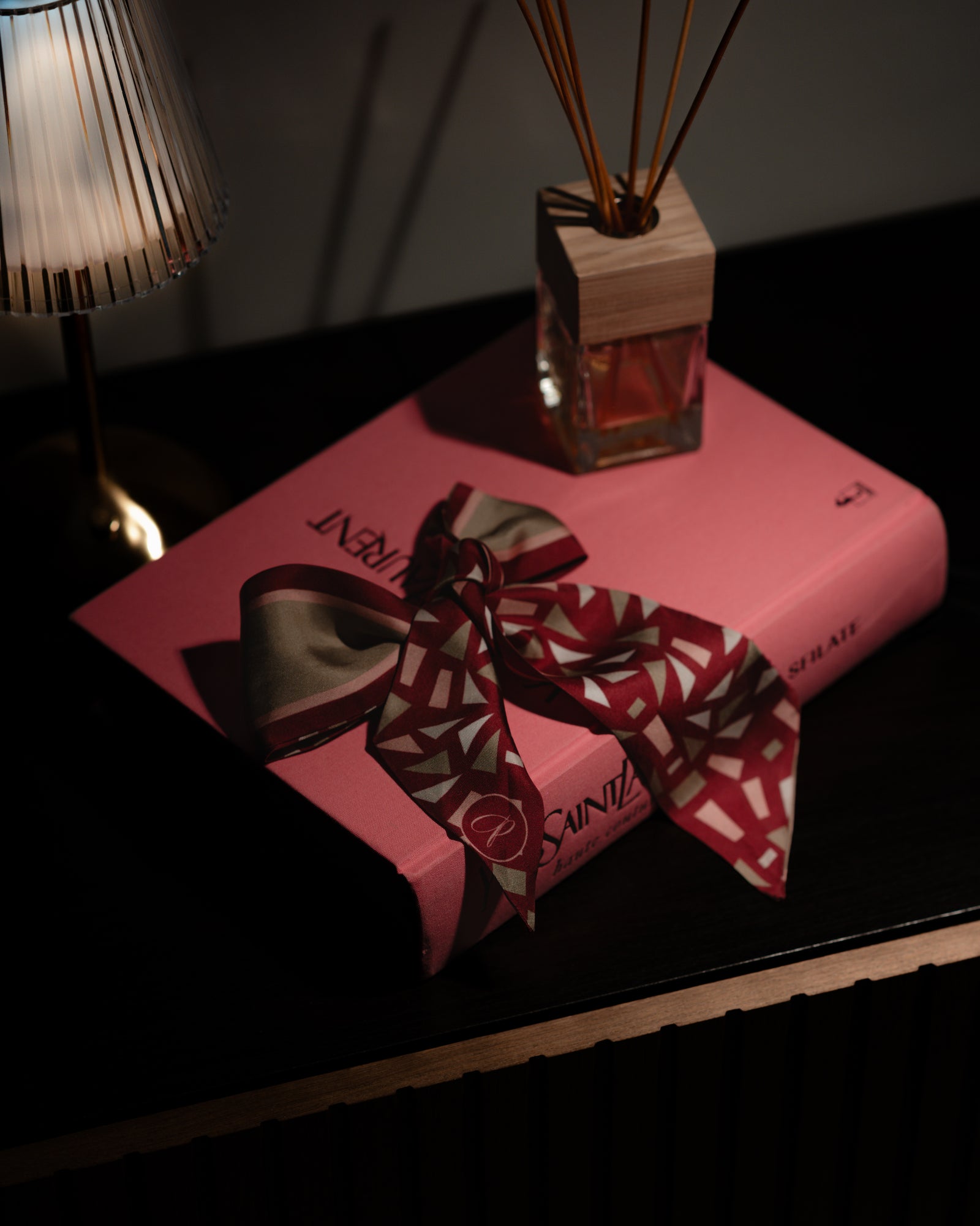 Silk elegant bourgundy willy woman accessorie on a book 