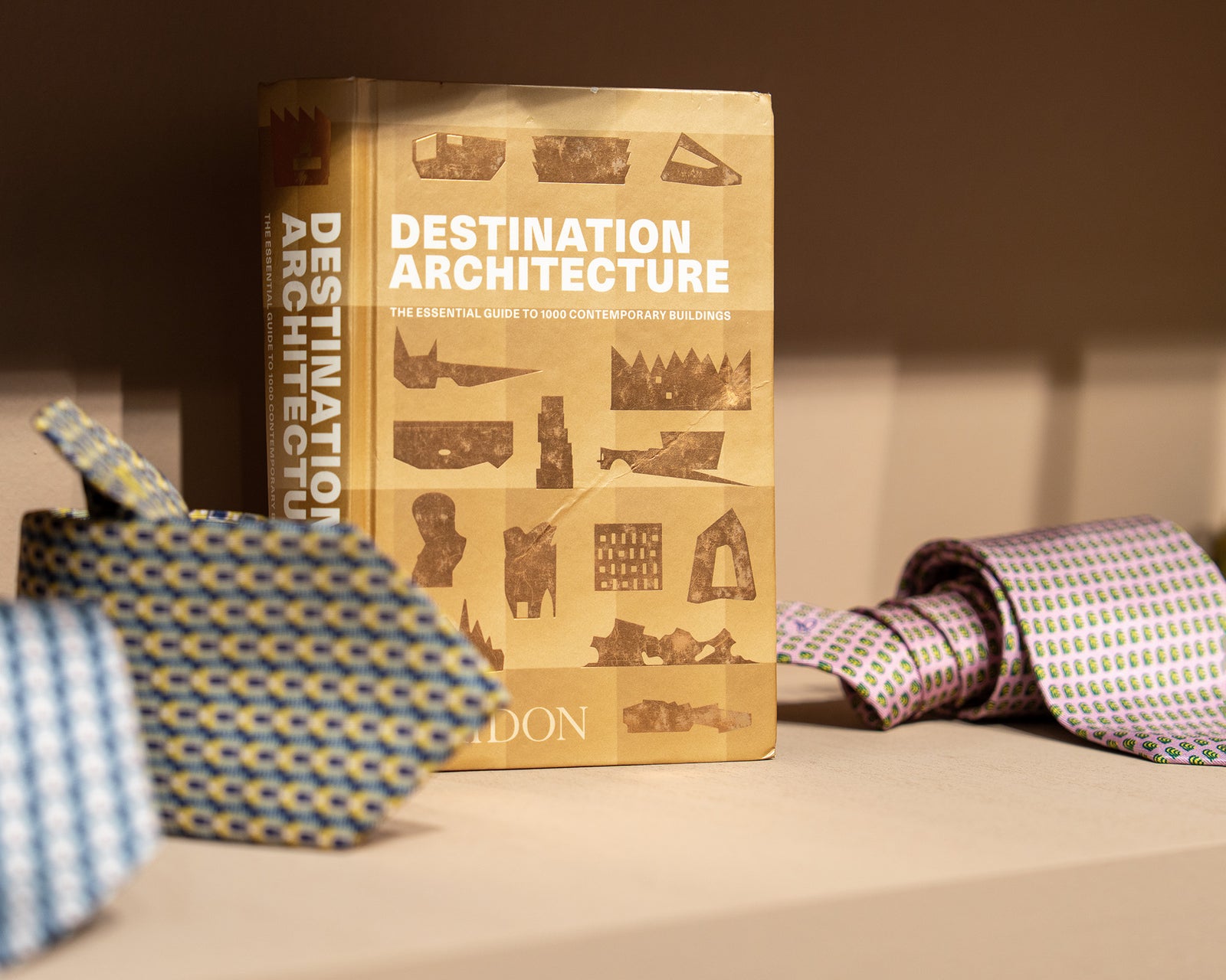 Book titled 'Destination Architecture' with decorative items on a surface