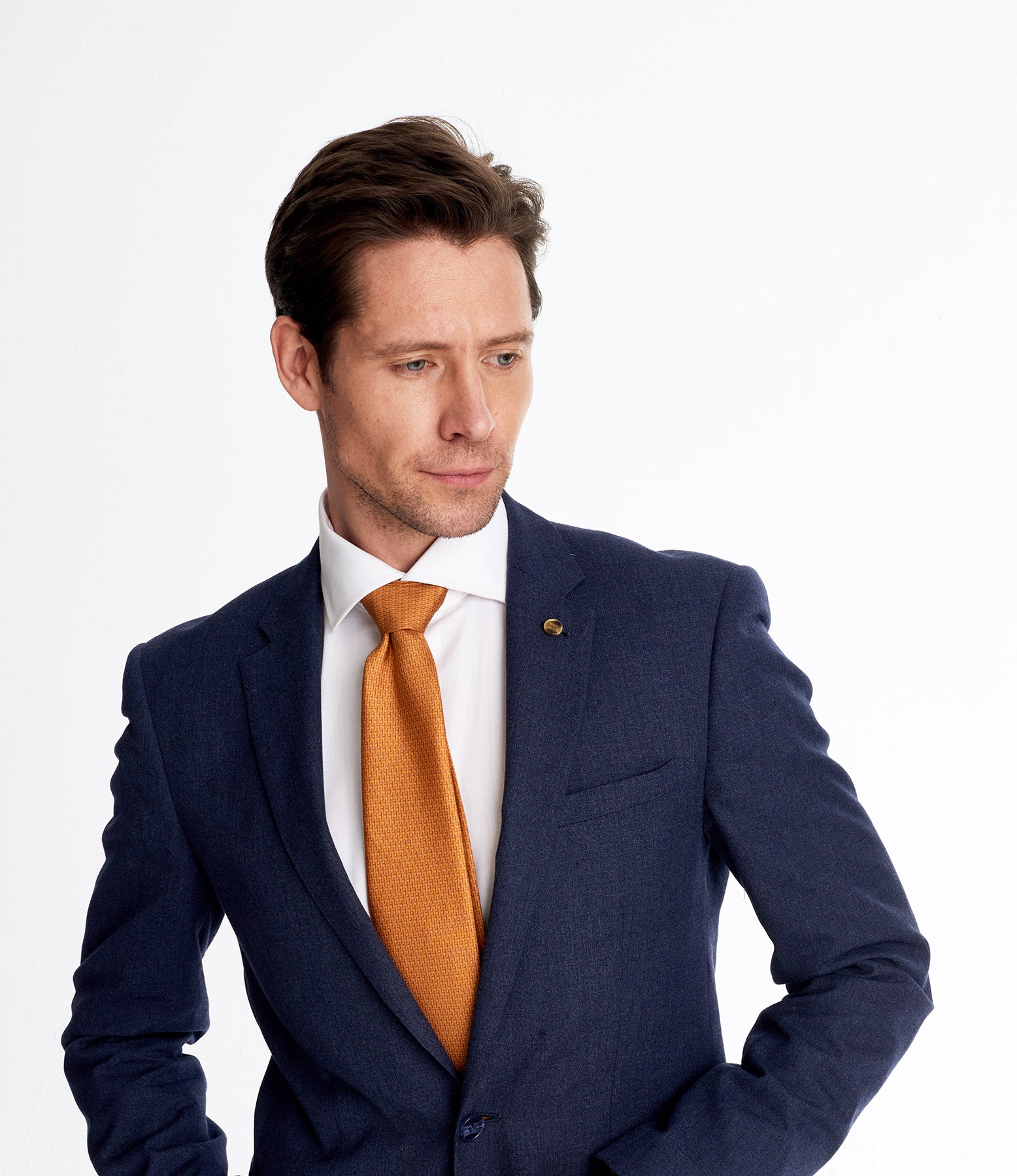 Elegant man wearing an orange geometric silk tie