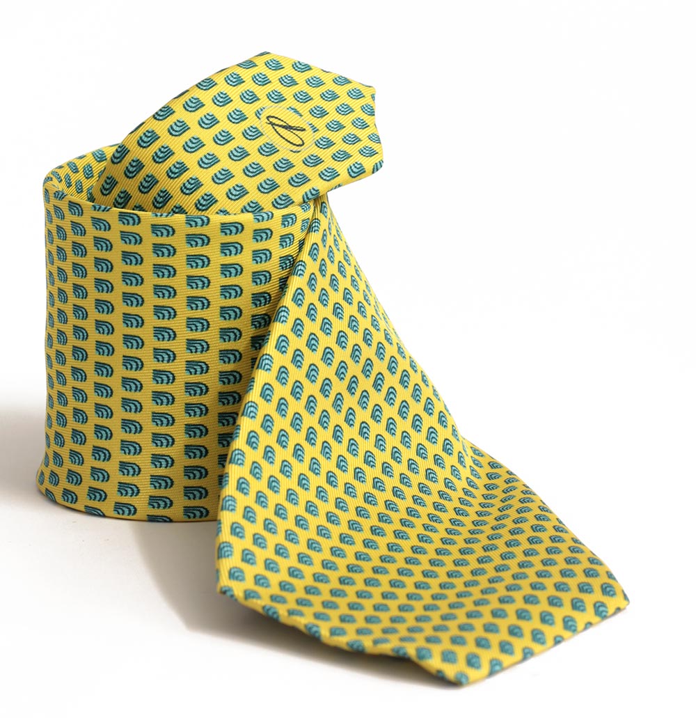 A yellow tie with a geometric pattern, displayed in a folded position.
